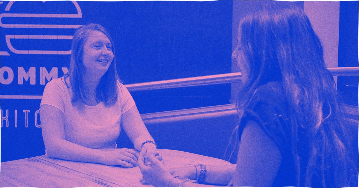 Two people sat in Tommy's Kitchen talking