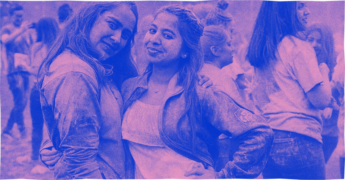 Two students covered in paint after participating in RHSU's Holi Festival event