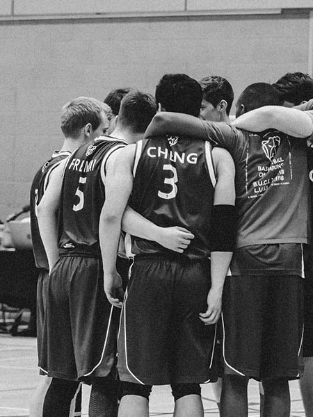 Royal Holloway's Men's Basketball team in a huddle