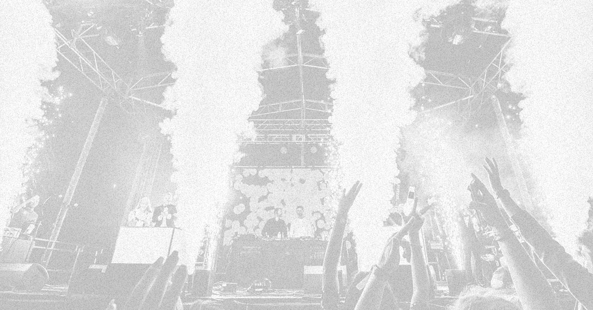 A photograph of four CO2 cannons firing in front of the main stage