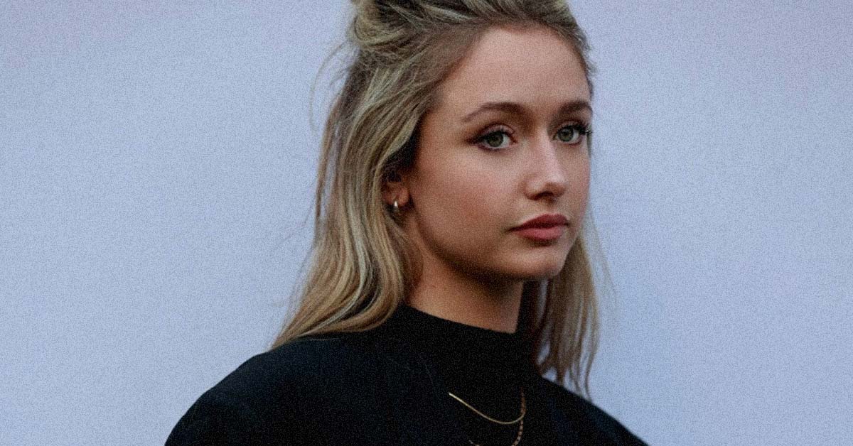 Katie Kittermaster wearing a black rollneck jumper with two gold necklaces hanging over the top