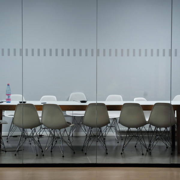 A photograph of chairs around a table in a boardroom. Photo by Pawel Chu on Unsplash.