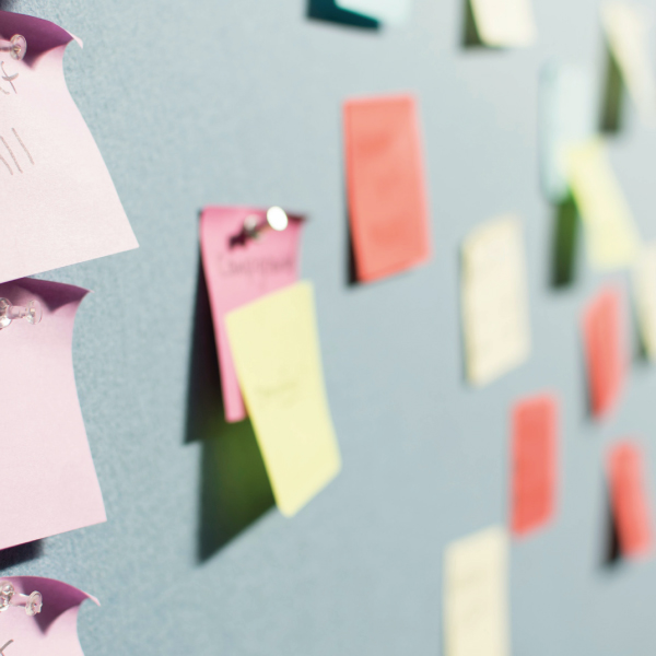 A photograph of sticky notes on a board. Photo by Patrick Perkins on Unsplash.